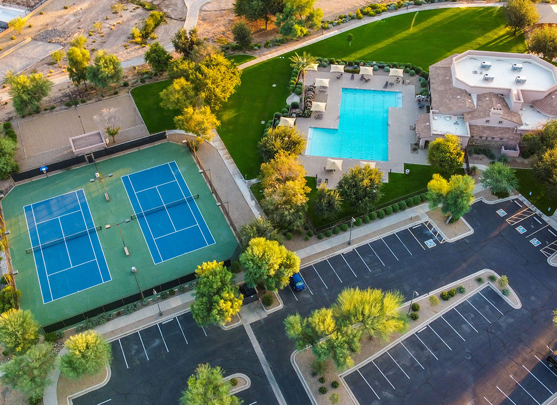Service Center - Aerial View of a Residential Clubhouse Containing a Tennis Court and an Outdoor Pool